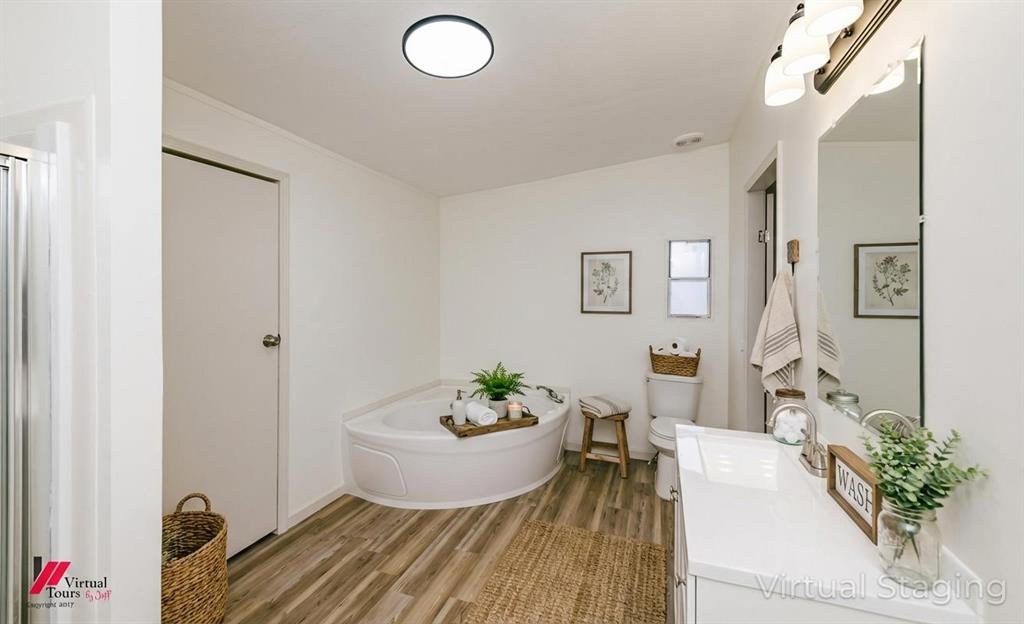 4947 Quiet Acres Road Shreveport, LA 71107 - Photo 11 of 39 Virtually Staged Full bathroom with vanity, a bath, and light wood-style flooring