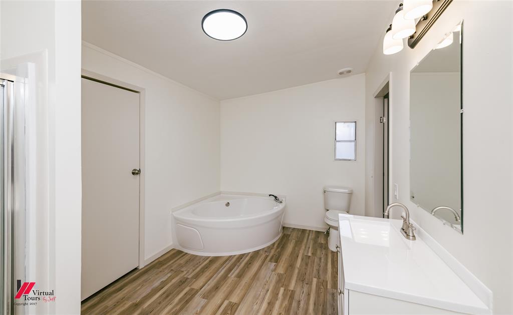 4947 Quiet Acres Road Shreveport, LA 71107 - Photo 12 of 39 Full bathroom featuring vanity, a garden tub, and light wood-style floors