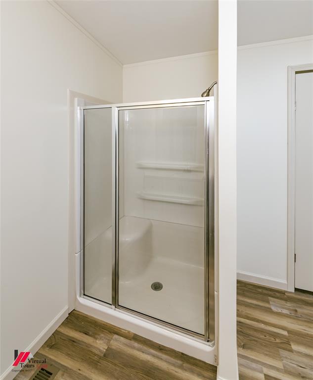 4947 Quiet Acres Road Shreveport, LA 71107 - Photo 13 of 39 Full bathroom featuring light wood finished floors, a shower stall, and ornamental molding