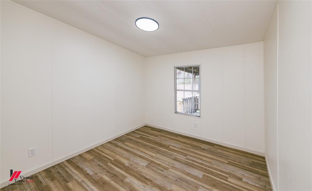 4947 Quiet Acres Road Shreveport, LA 71107 - Photo 17 of 39 Unfurnished room with a decorative wall and wood finished floors