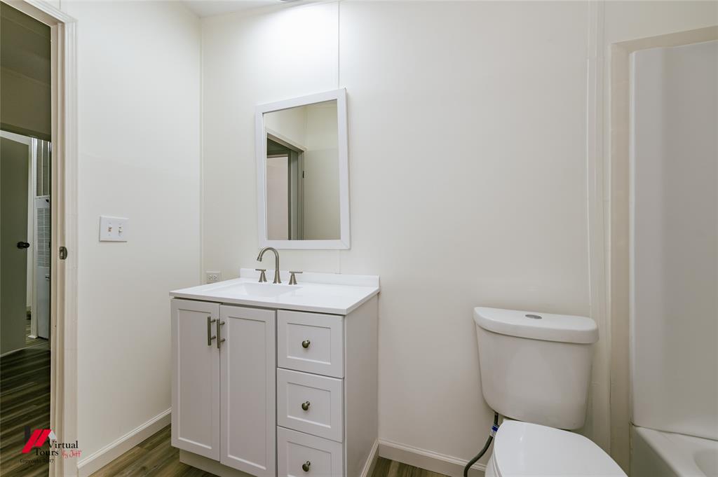 4947 Quiet Acres Road Shreveport, LA 71107 - Photo 21 of 39 Bathroom featuring vanity, dark wood-style floors, and shower / bath combination