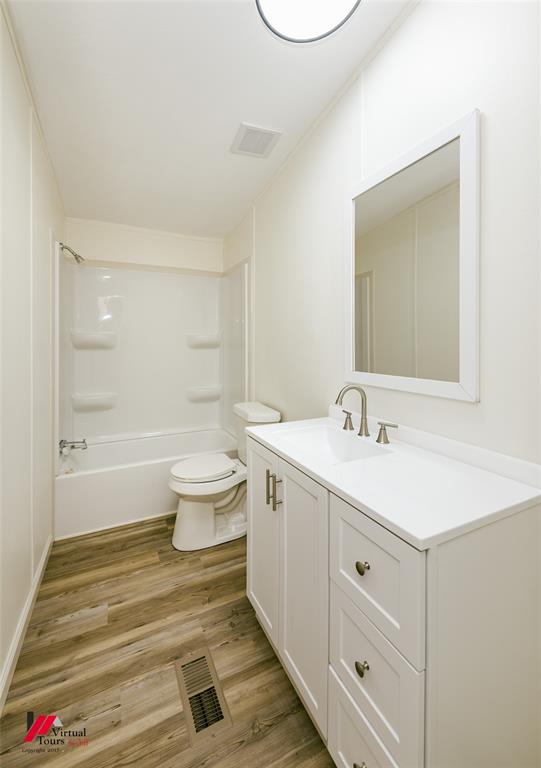4947 Quiet Acres Road Shreveport, LA 71107 - Photo 22 of 39 Bathroom with light wood-style flooring, vanity, and shower / tub combination