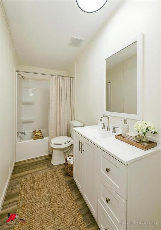 4947 Quiet Acres Road Shreveport, LA 71107 - Photo 23 of 39 Full bath featuring shower / bath combo with shower curtain, dark wood finished floors, and vanity
