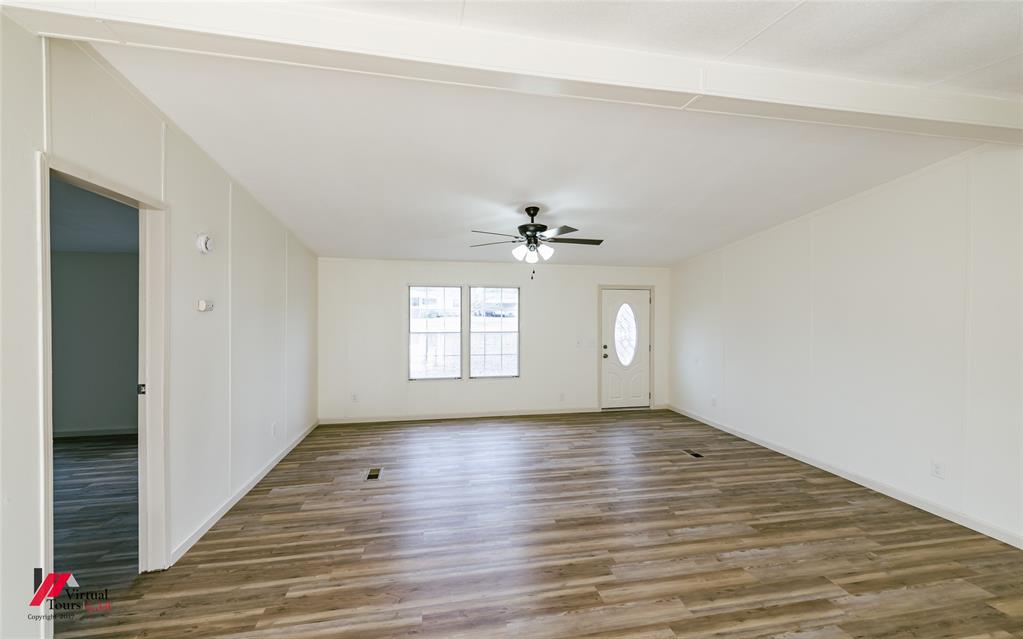 4947 Quiet Acres Road Shreveport, LA 71107 - Photo 36 of 39 Virtually Staged Living area featuring wood finished floors, a ceiling fan, arched walkways, and a stone fireplace
