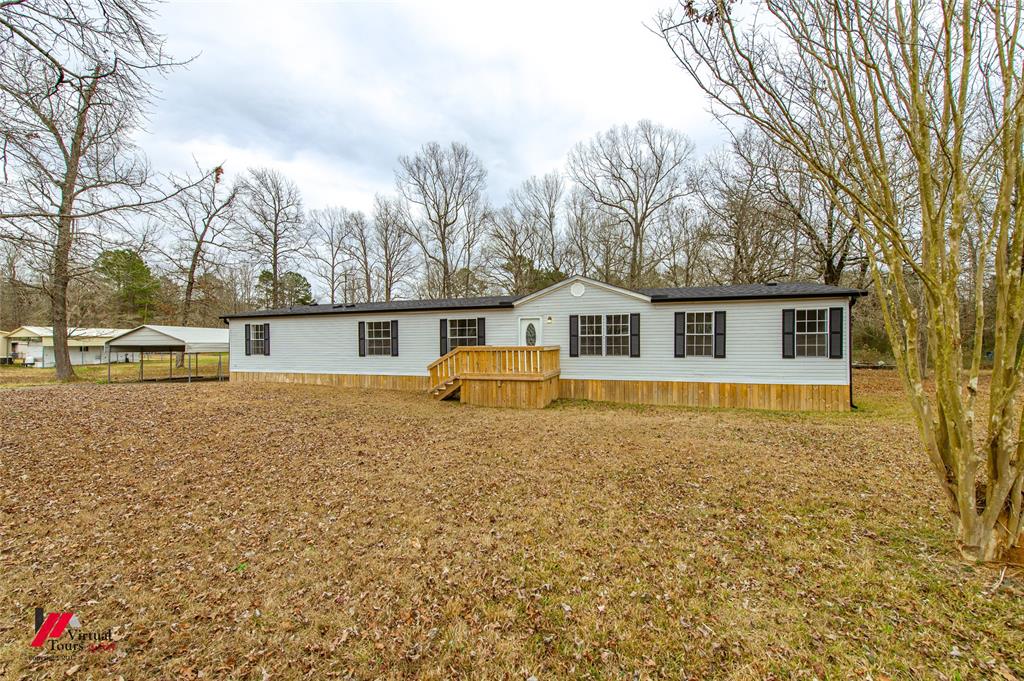 4947 Quiet Acres Road Shreveport, LA 71107 - Photo 37 of 39 Manufactured / mobile home featuring a wooden deck and a detached carport