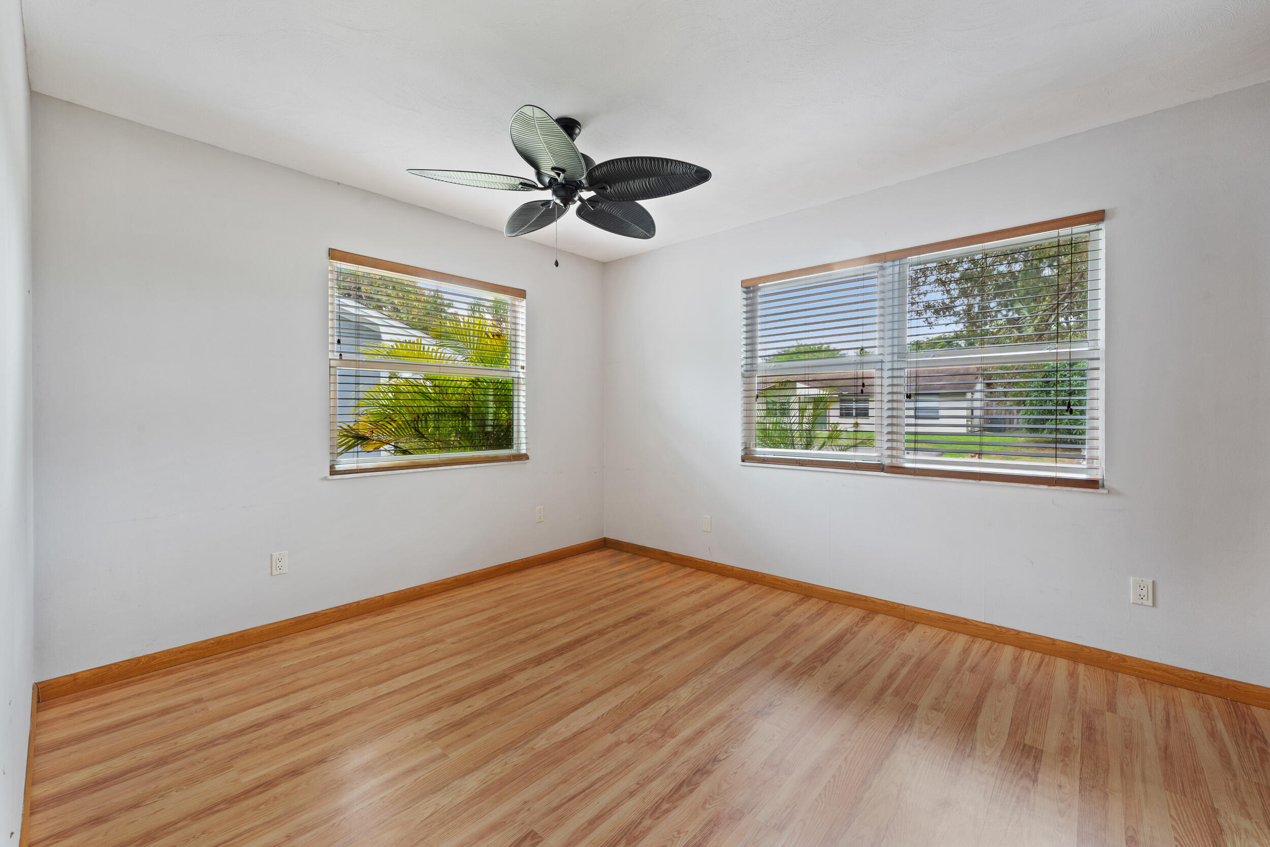 5345 Southeast 52nd Avenue Stuart, FL 34997 - Photo 12 of 32 a view of empty room with wooden floor and fan
