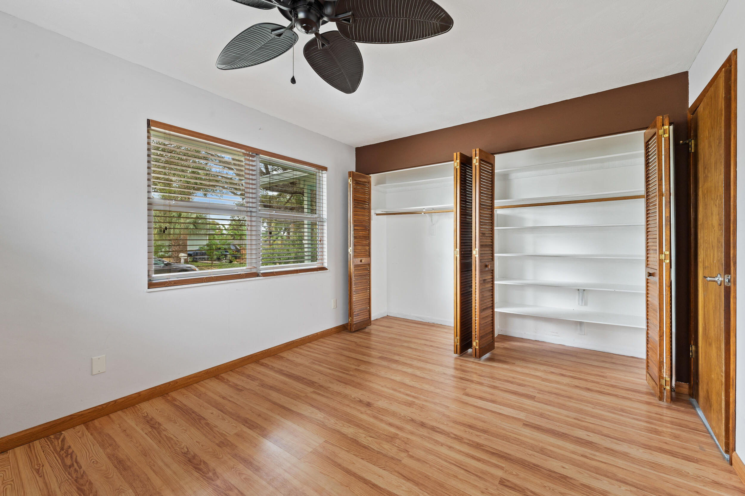 5345 Southeast 52nd Avenue Stuart, FL 34997 - Photo 13 of 32 a view of an empty room with a window and wooden floor
