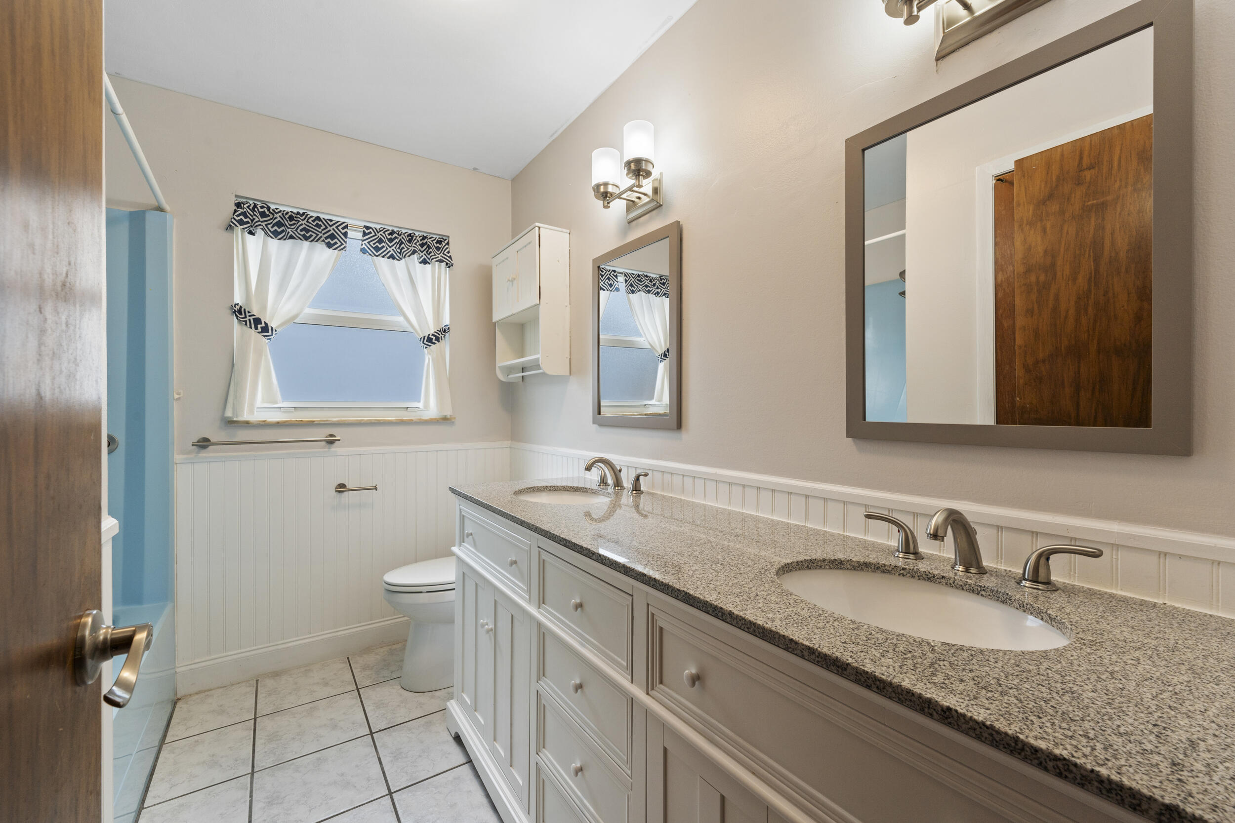 5345 Southeast 52nd Avenue Stuart, FL 34997 - Photo 15 of 32 a bathroom with a granite countertop sink and a mirror