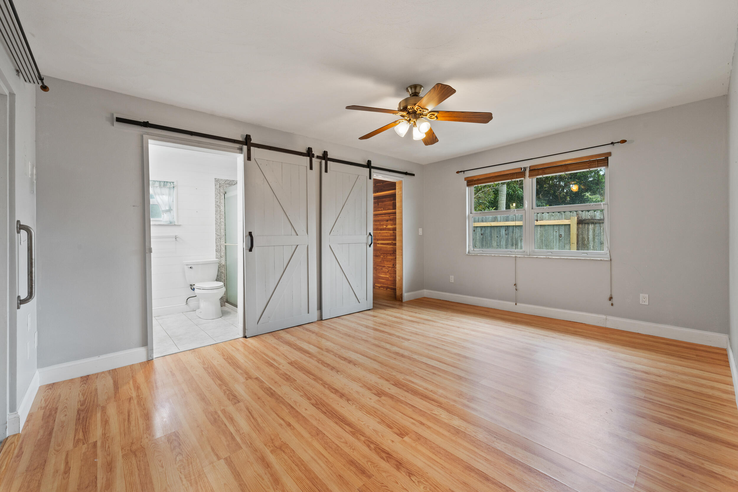 5345 Southeast 52nd Avenue Stuart, FL 34997 - Photo 17 of 32 a view of empty room with wooden floor and fan