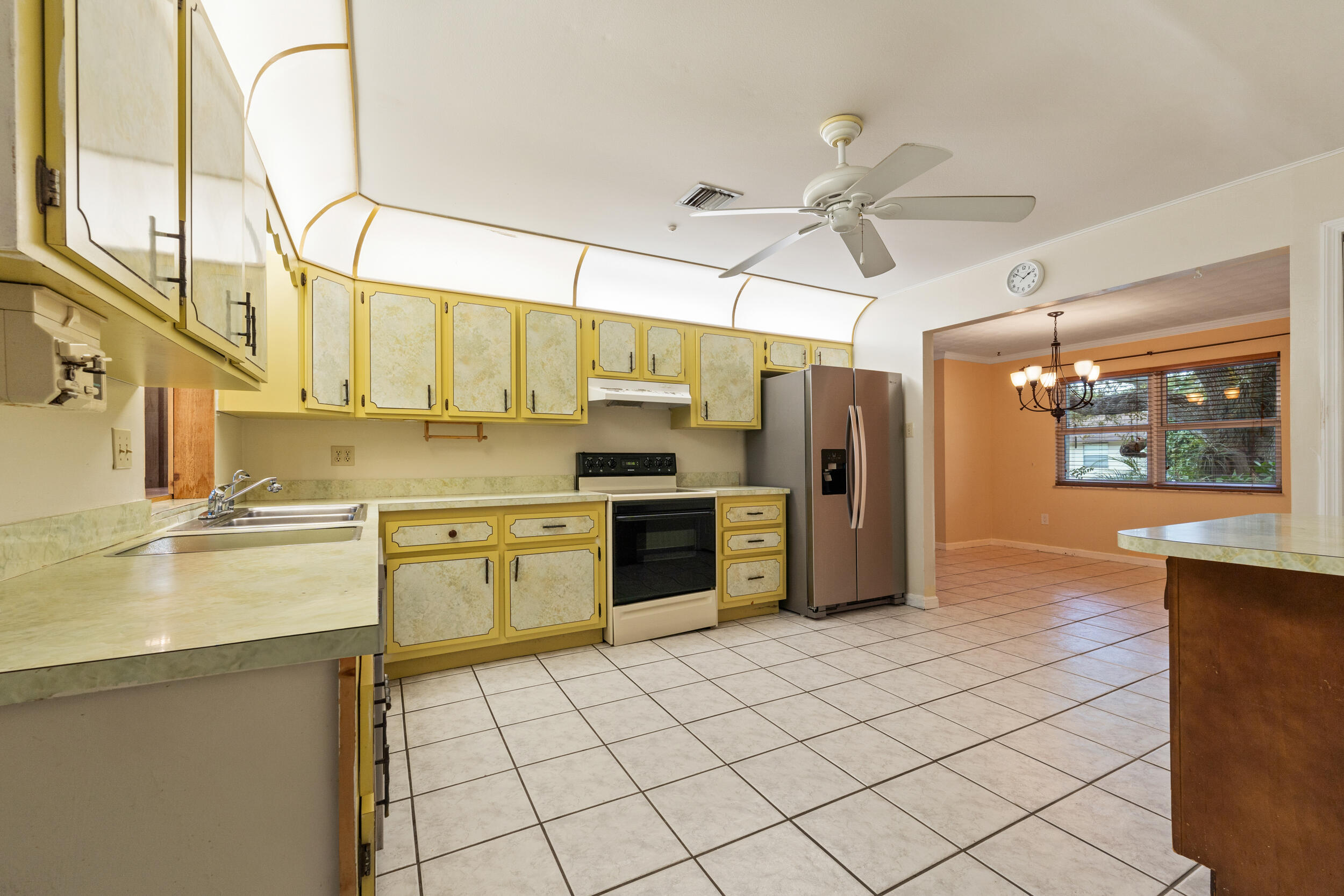 5345 Southeast 52nd Avenue Stuart, FL 34997 - Photo 5 of 32 a kitchen with stainless steel appliances granite countertop a refrigerator and a sink