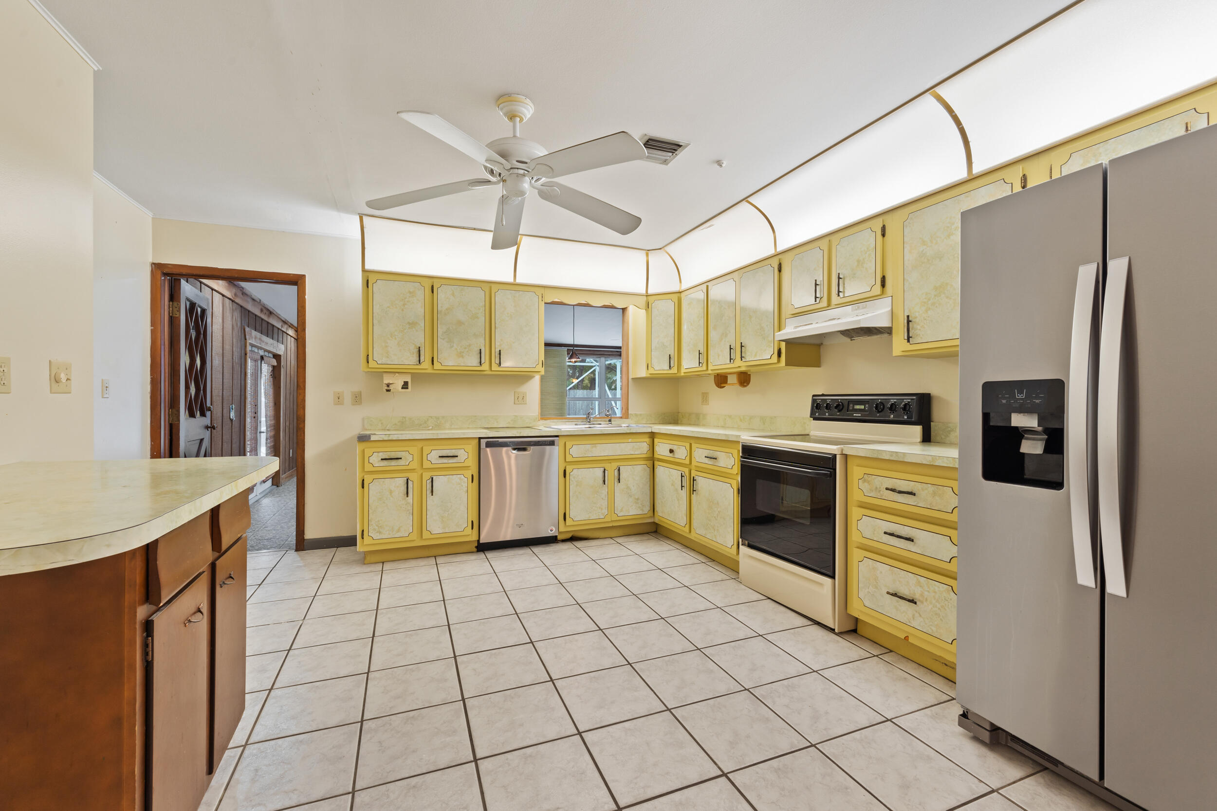 5345 Southeast 52nd Avenue Stuart, FL 34997 - Photo 6 of 32 a kitchen with stainless steel appliances a refrigerator sink and cabinets