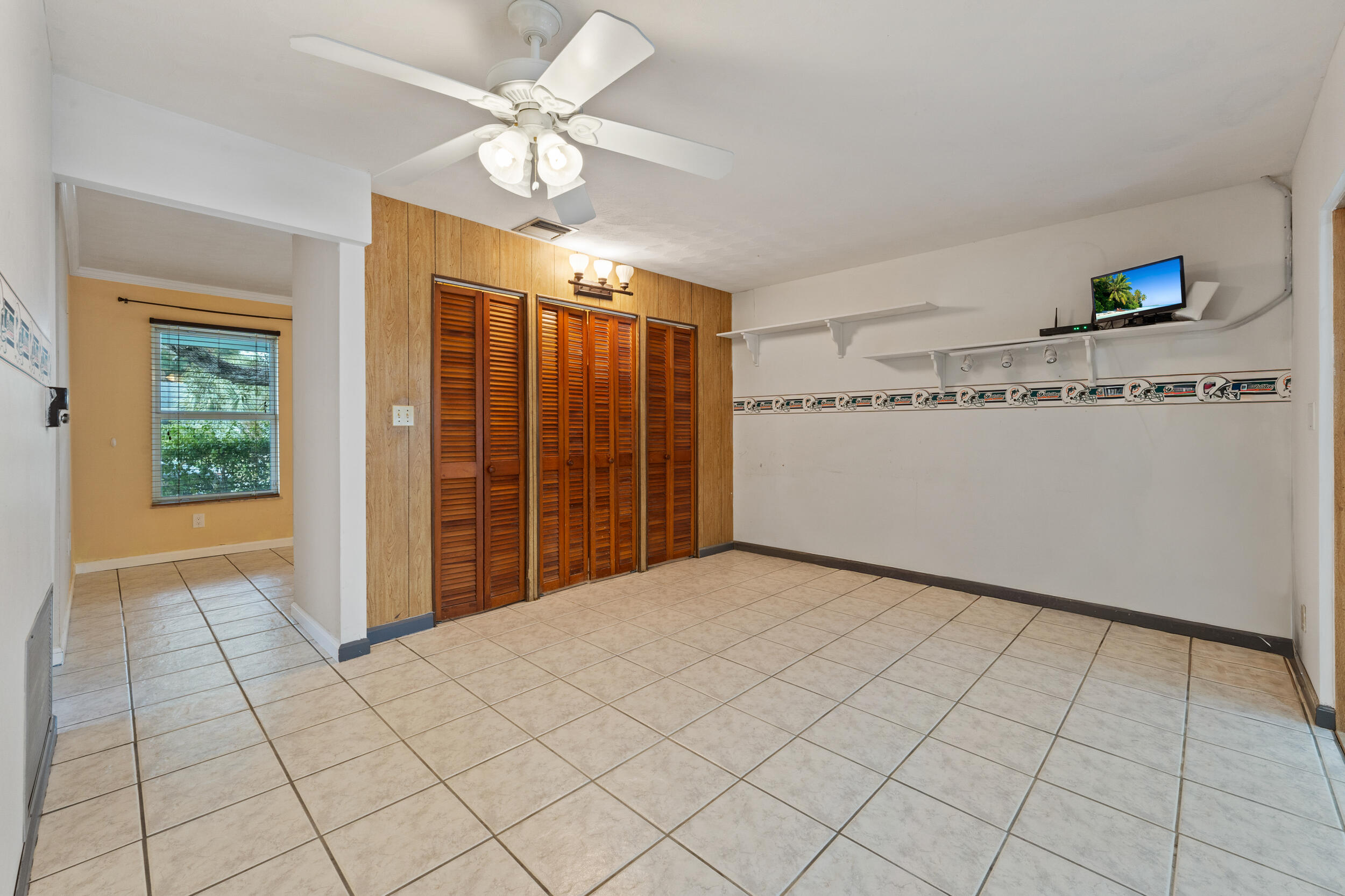 5345 Southeast 52nd Avenue Stuart, FL 34997 - Photo 10 of 32 a view of a livingroom with an empty space and a ceiling fan
