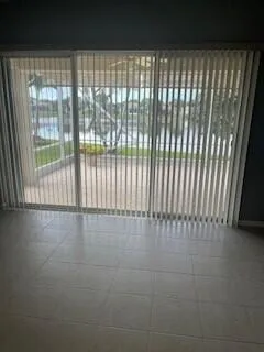 a view of an empty room with floor to ceiling window