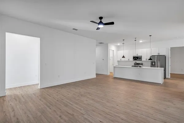 a kitchen with appliances a microwave and cabinets