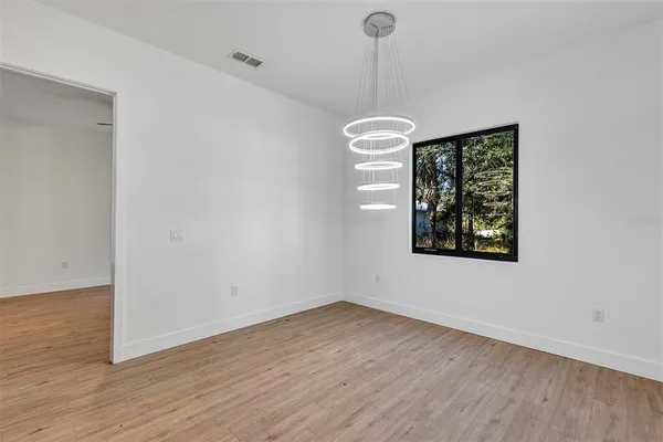 a view of a room with wooden floor and window