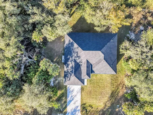 an aerial view of a house with a yard