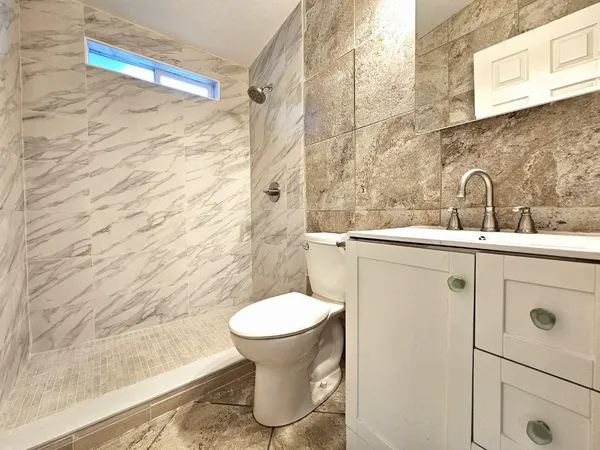 a bathroom with a sink toilet and shower