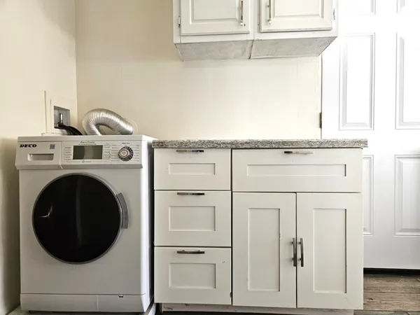 a close view of a utility room with dryer and washer