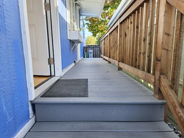 a view of balcony with wooden floor and potted plants