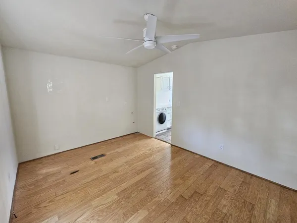 a living room with furniture and a book shelf