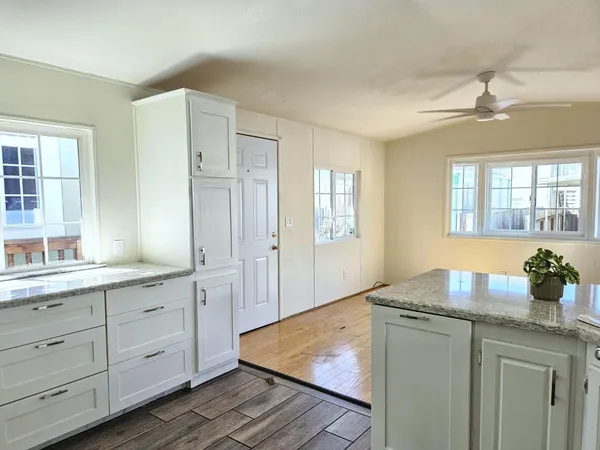 a kitchen with cabinets and window