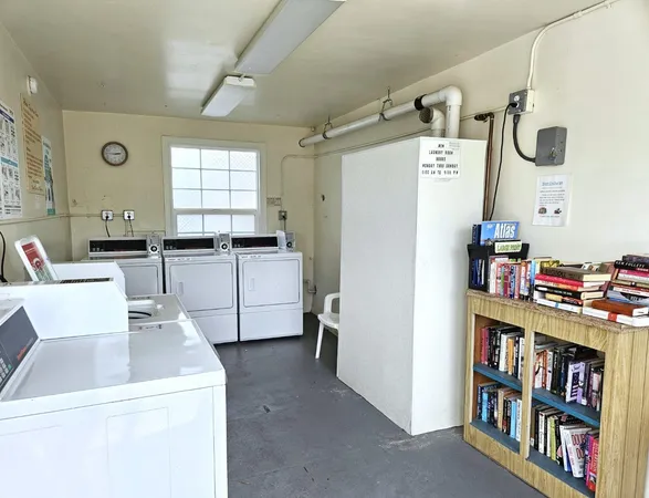 a view of kitchen with refrigerator and window