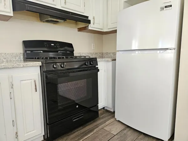 a stove top oven sitting inside of a kitchen