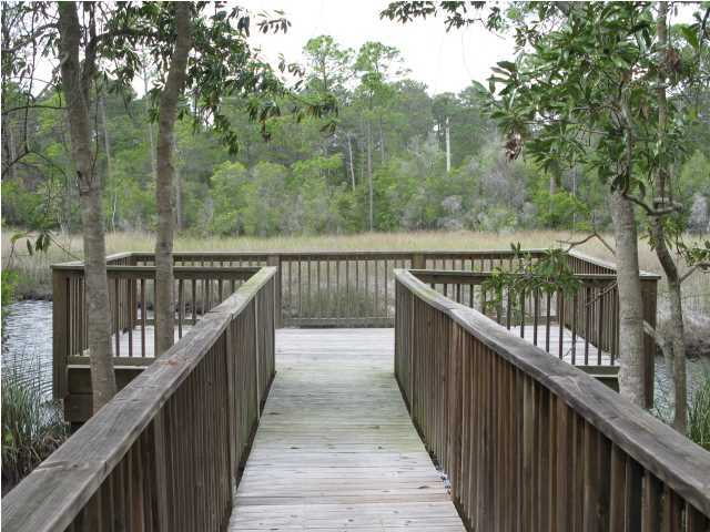 1 Lake Mist Ln Inlet Beach Inlet Beach, FL 32461 - Photo 6 of 7 a view of a balcony with wooden deck and trees