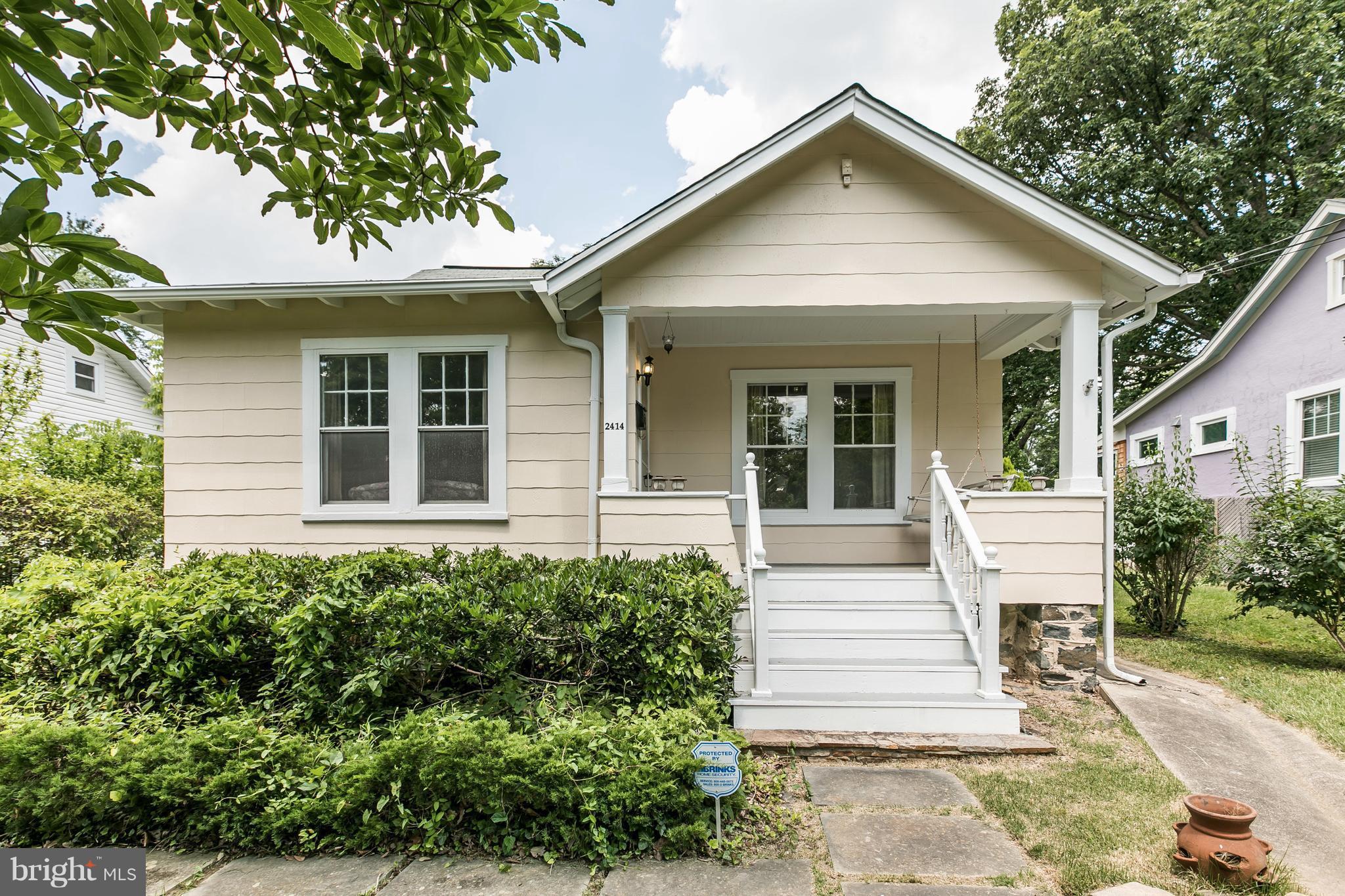 2414 Steele Road Baltimore, MD 21209 - Photo 2 of 24 a front view of a house with a yard and trees
