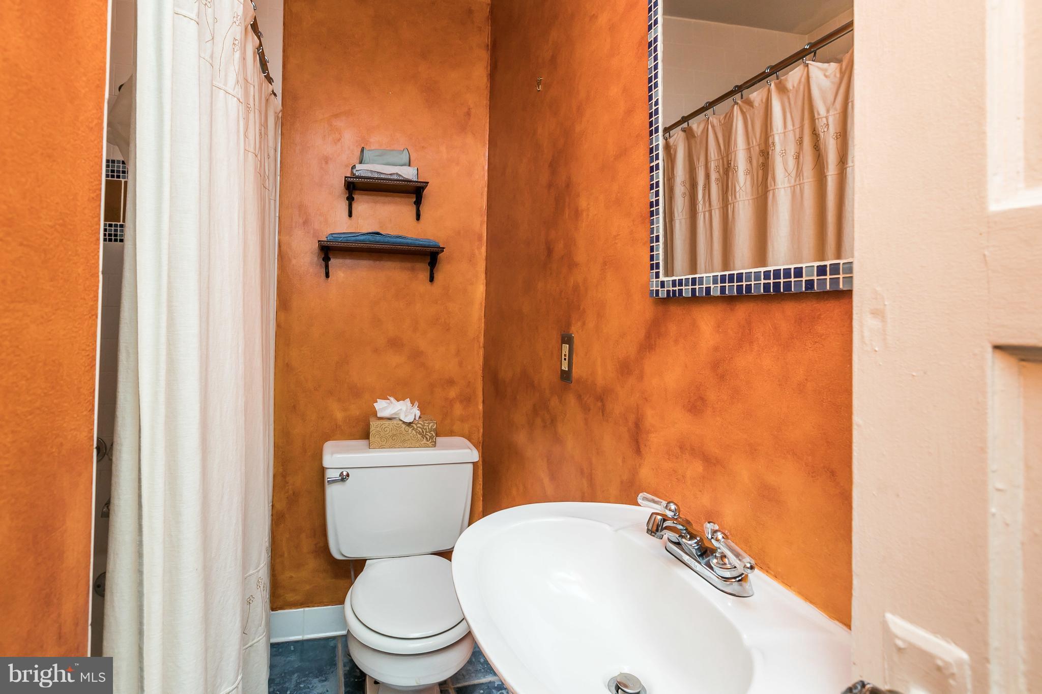 2414 Steele Road Baltimore, MD 21209 - Photo 12 of 24 a bathroom with a sink and a toilet