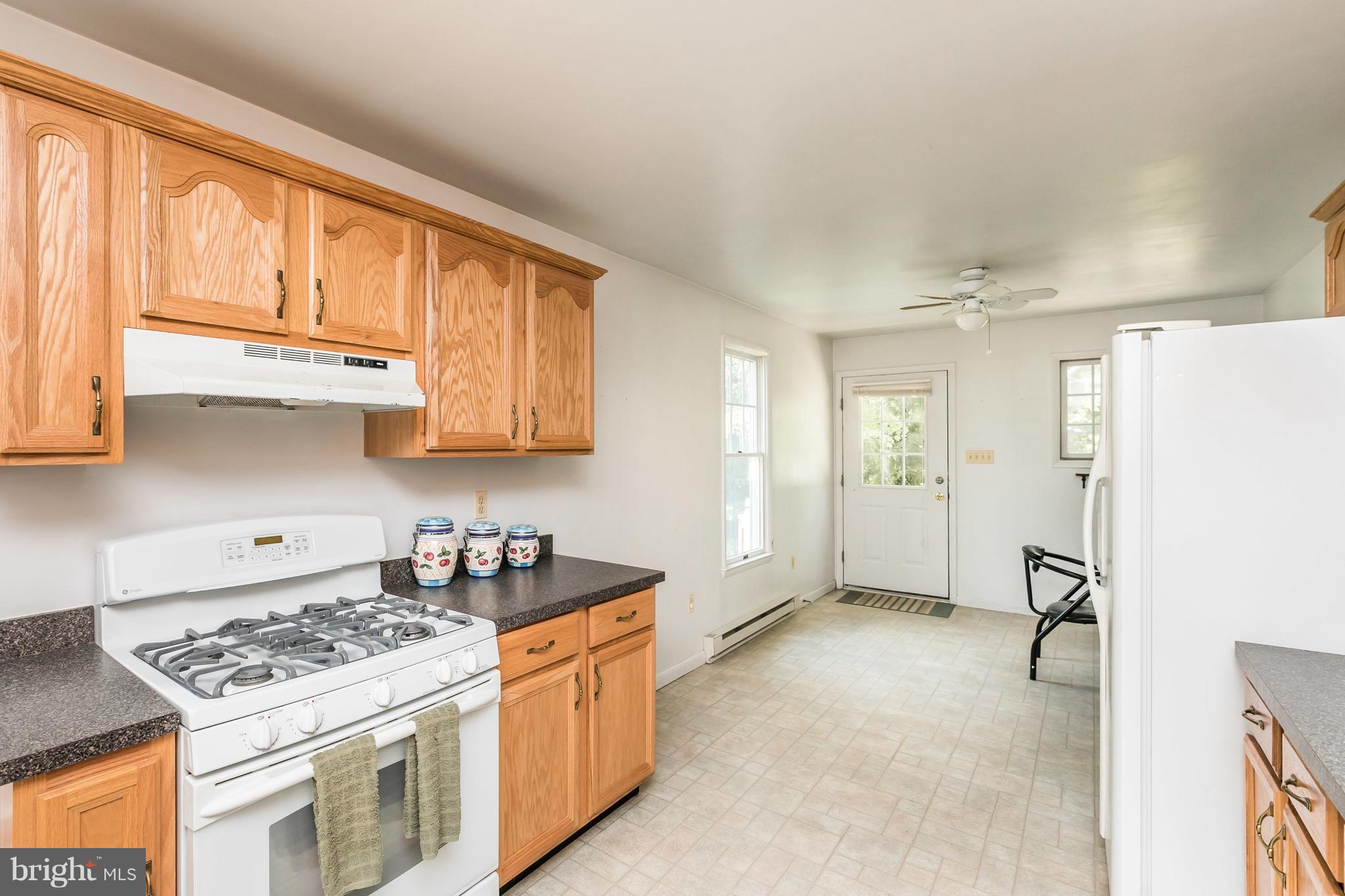 2414 Steele Road Baltimore, MD 21209 - Photo 15 of 24 a kitchen with stainless steel appliances granite countertop a stove a sink and a refrigerator