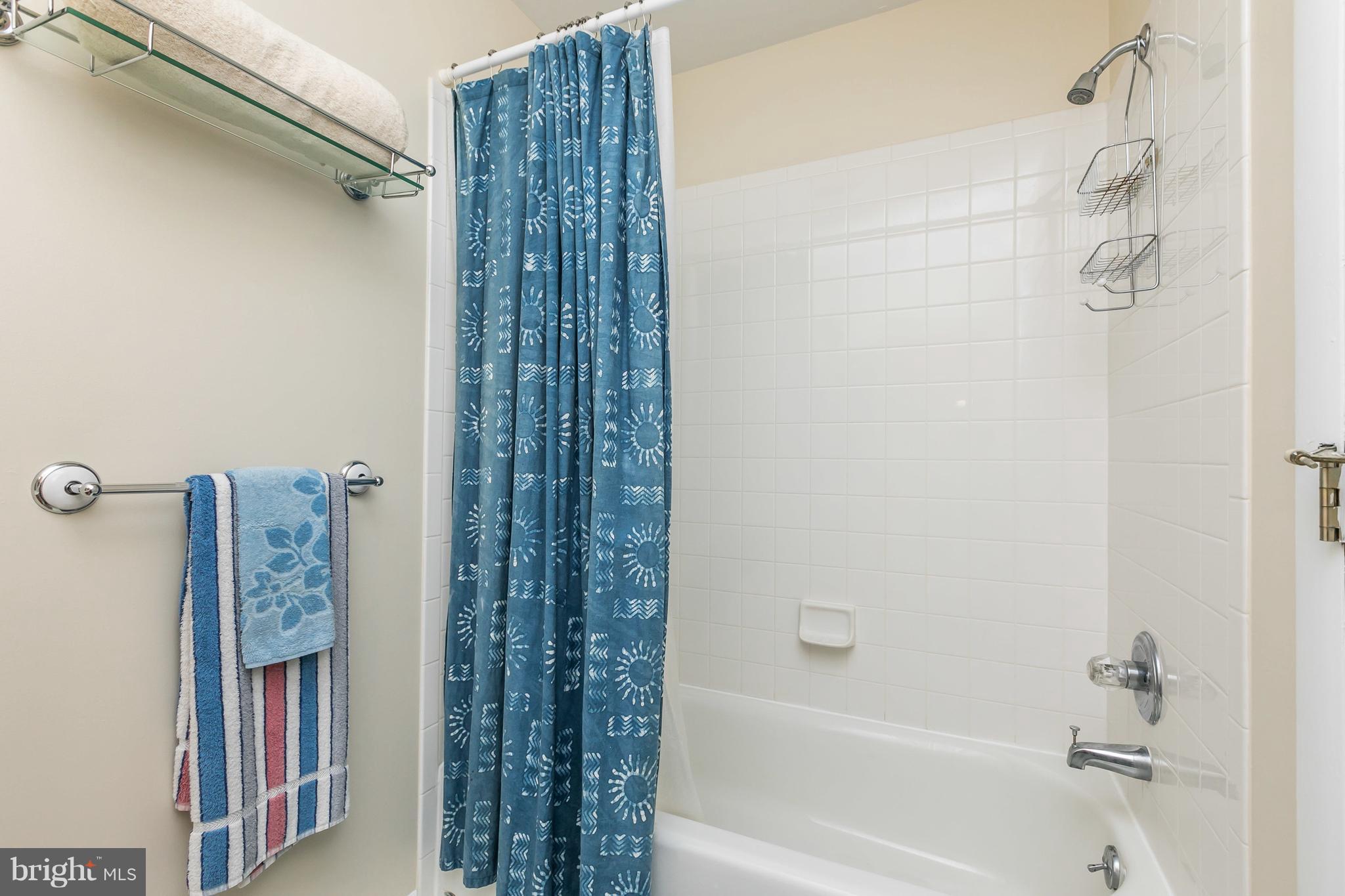 2414 Steele Road Baltimore, MD 21209 - Photo 19 of 24 a bathroom with a shower curtain and a bath tub