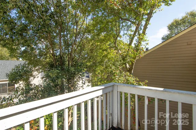 a balcony with trees in front of it