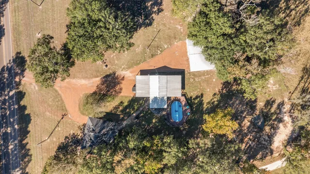 a view of a yard with wooden fence