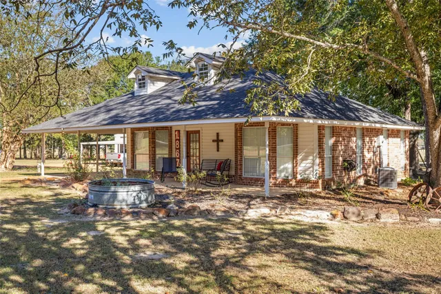 a living room with furniture kitchen view and a large window