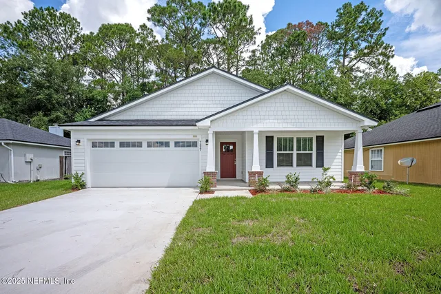 a front view of house with yard outdoor seating and green space