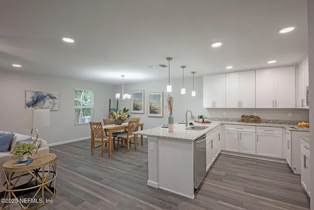 a kitchen with a sink stove and cabinets