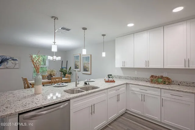 a kitchen with stainless steel appliances granite countertop a sink stove and cabinets