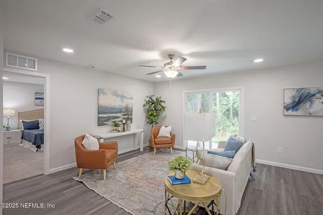 a living room with furniture and a large window