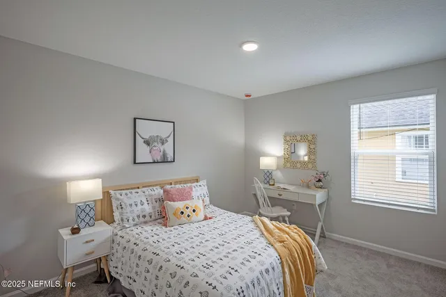 a bedroom with a bed and a painting on the wall