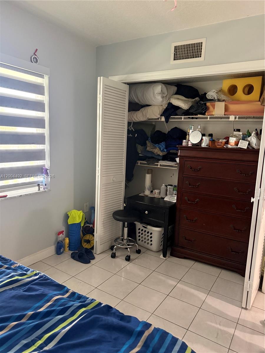 9880 Marina Boulevard, Unit 1528 Boca Raton, FL 33428 - Photo 14 of 14 a room with furniture and a window
