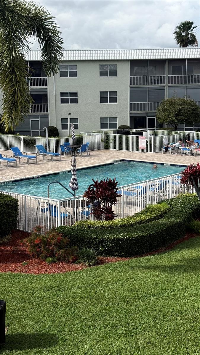 9880 Marina Boulevard, Unit 1528 Boca Raton, FL 33428 - Photo 2 of 14 a view of swimming pool with outdoor seating and a garden