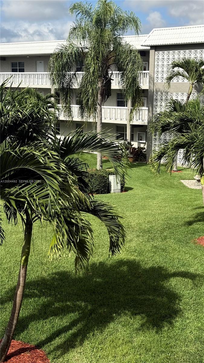 9880 Marina Boulevard, Unit 1528 Boca Raton, FL 33428 - Photo 3 of 14 a view of a house with a yard