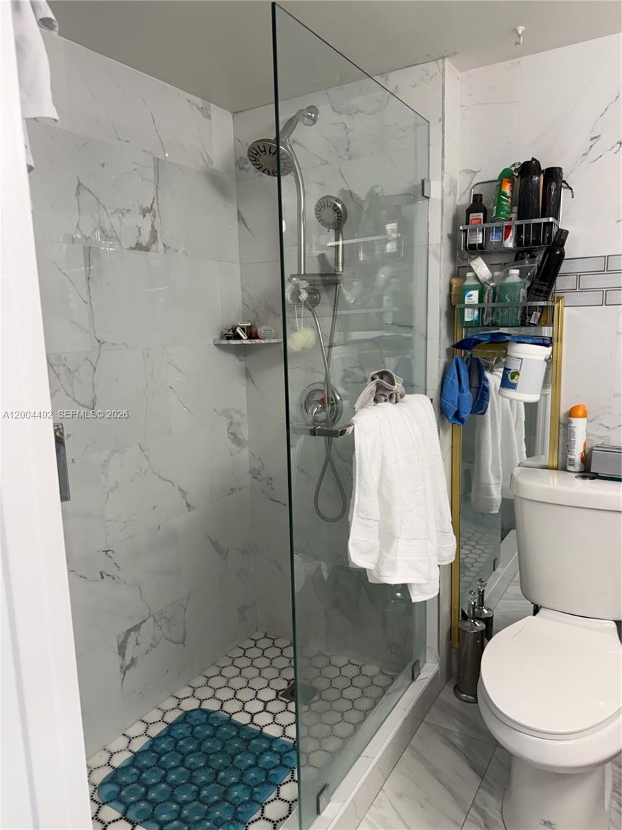 9880 Marina Boulevard, Unit 1528 Boca Raton, FL 33428 - Photo 6 of 14 a bathroom with a shower