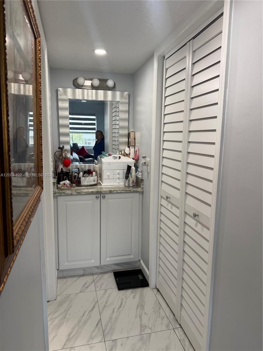 9880 Marina Boulevard, Unit 1528 Boca Raton, FL 33428 - Photo 7 of 14 a bathroom with a sink a vanity and a shower