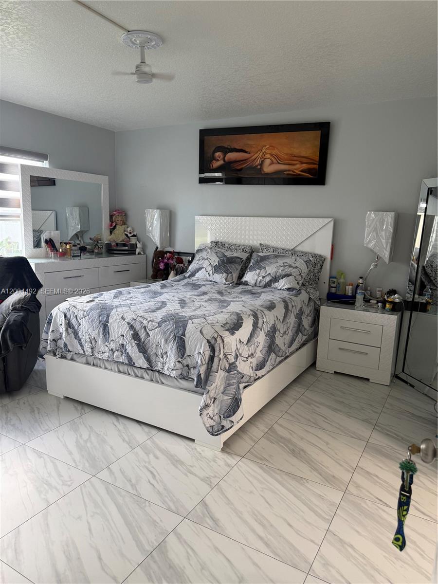 9880 Marina Boulevard, Unit 1528 Boca Raton, FL 33428 - Photo 8 of 14 a bedroom with a bed and a couch