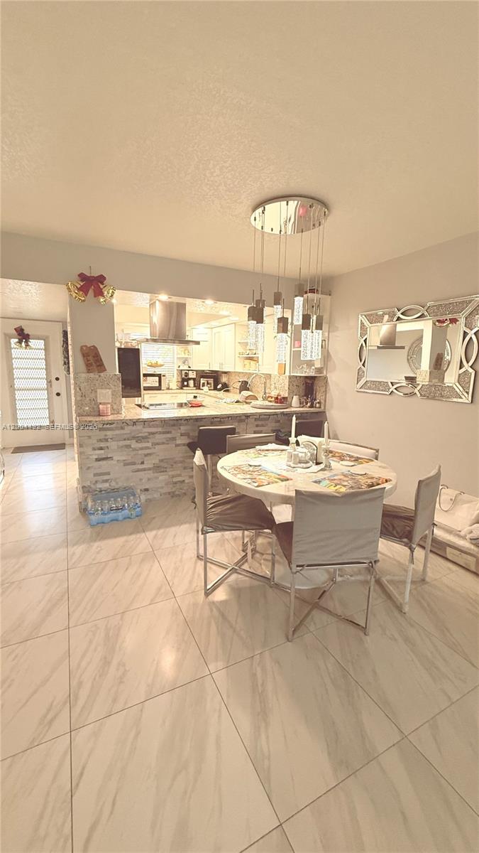 9880 Marina Boulevard, Unit 1528 Boca Raton, FL 33428 - Photo 10 of 14 a living room with couches and a dining table with kitchen view