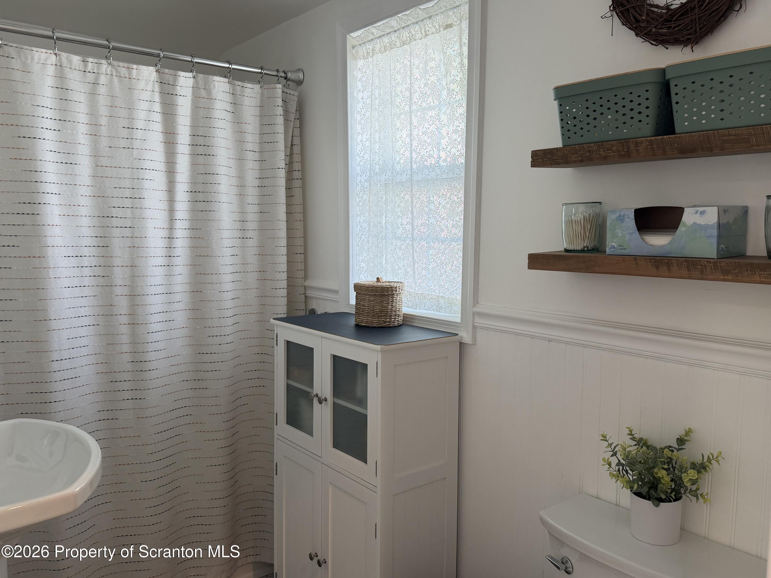 320 Haverly Street Throop, PA 18512 - Photo 19 of 27 a bathroom with a sink and a mirror
