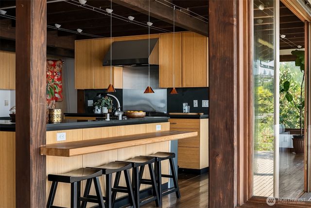 a kitchen with a table chairs and a window