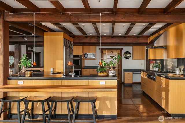 a kitchen with a table chairs refrigerator and stove